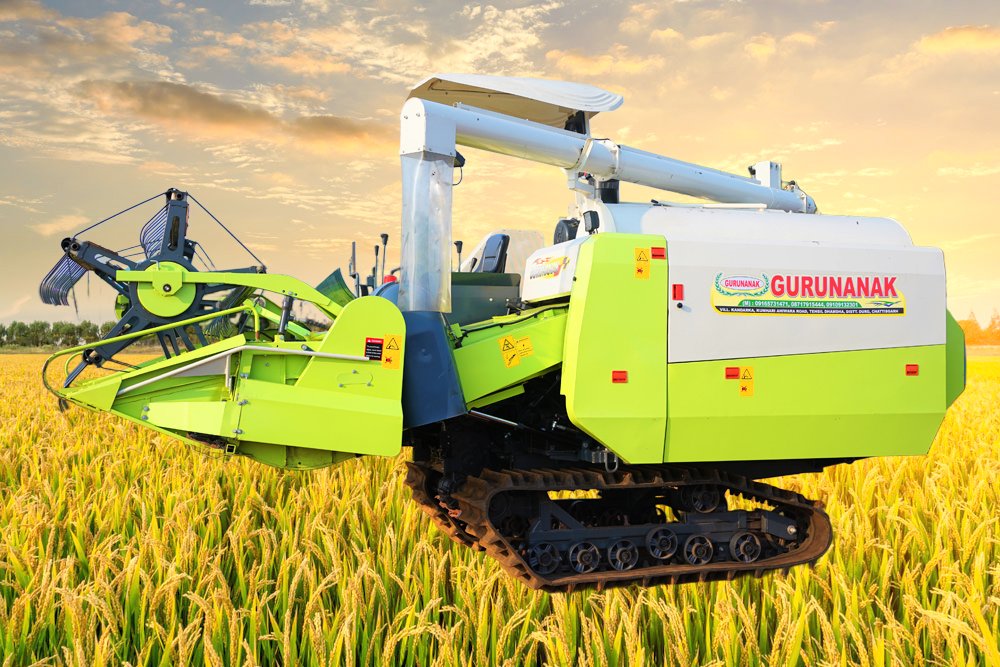 Green Gurunanak track combine harvester in a field of ripe grain